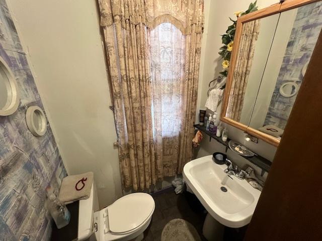 half bathroom with a sink and toilet