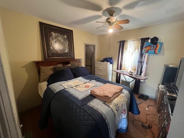 bedroom with ceiling fan and wood finished floors