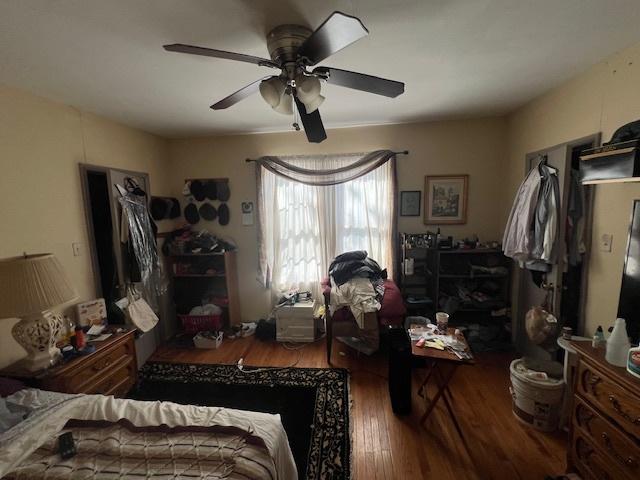 bedroom with a ceiling fan and wood finished floors
