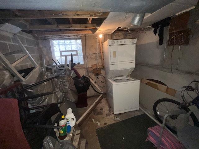 basement with stacked washer and clothes dryer