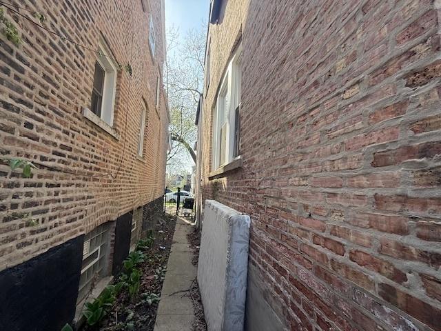view of side of property featuring brick siding