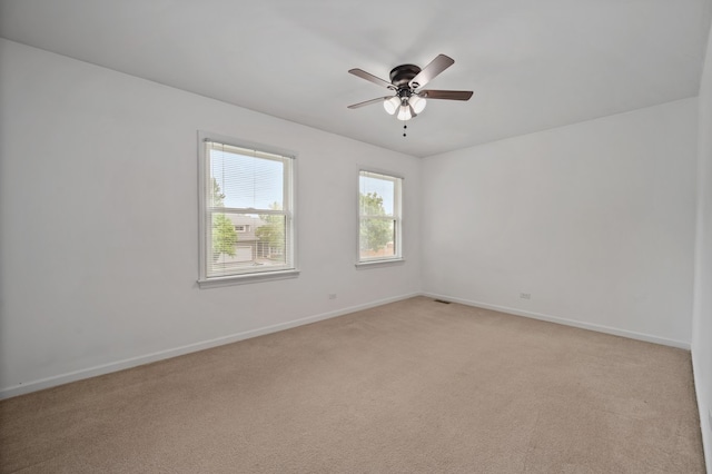 848 Stewart St, Batavia, IL 60510 - spare room featuring baseboards, light carpet, and a ceiling fan