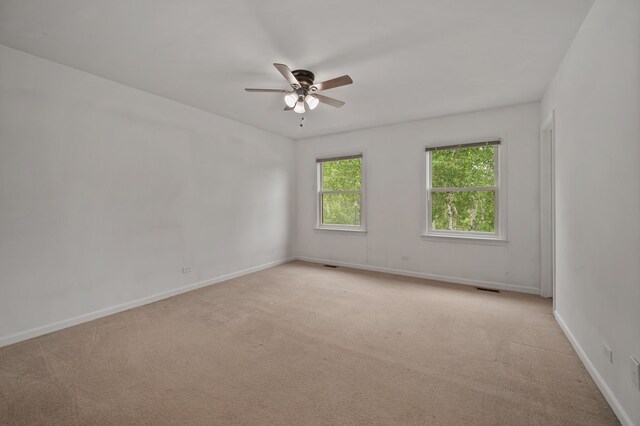 848 Stewart St, Batavia, IL 60510 - spare room featuring a ceiling fan, light carpet, and baseboards