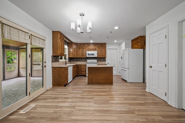 848 Stewart St, Batavia, IL 60510 - kitchen featuring white appliances, a chandelier, brown cabinetry, light wood-style floors, and recessed lighting