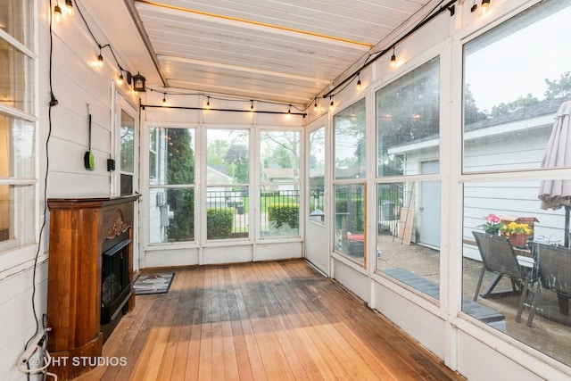 224 Howard Ave, East Dundee, IL 60118 - unfurnished sunroom featuring a fireplace with raised hearth