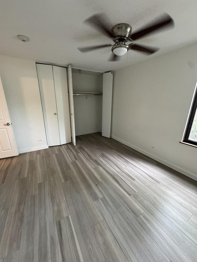 420 Walnut Creek Ln Unit 3103, Lisle, IL 60532 - unfurnished bedroom with wood finished floors, multiple closets, ceiling fan, and baseboards