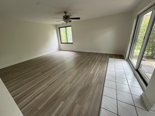 420 Walnut Creek Ln Unit 3103, Lisle, IL 60532 - unfurnished room with light wood-type flooring, ceiling fan, and baseboards