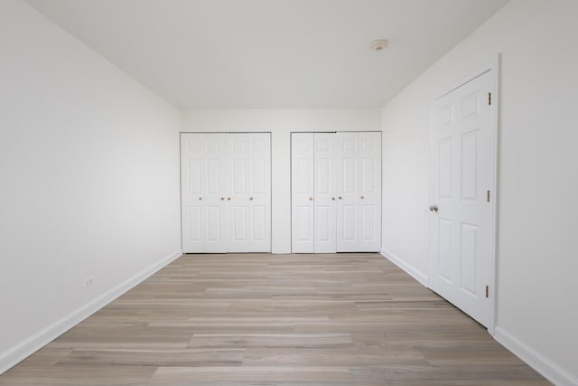 420 Walnut Creek Ave Unit 3103, Lisle, IL 60532 - unfurnished bedroom featuring two closets and light wood-style floors
