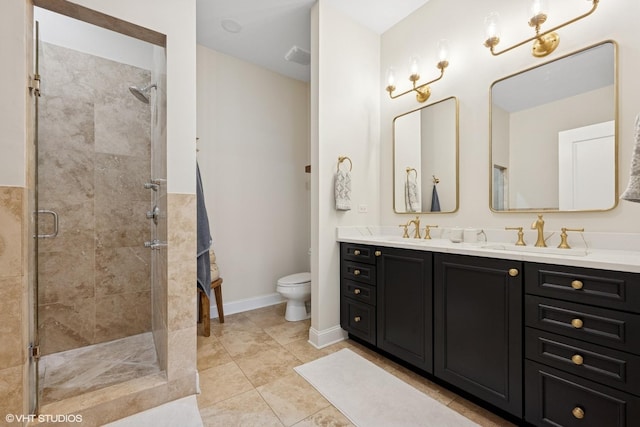 full bathroom with double vanity, toilet, a sink, and a stall shower