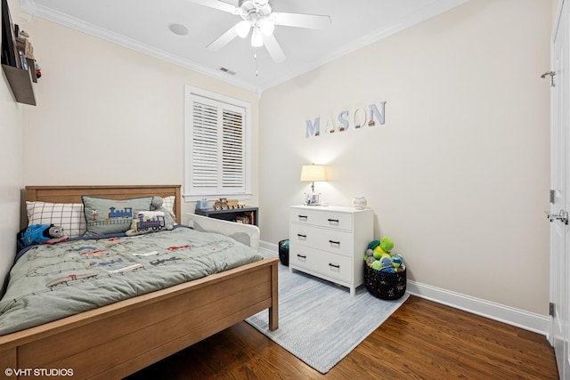 bedroom featuring baseboards, ornamental molding, dark wood finished floors, and visible vents