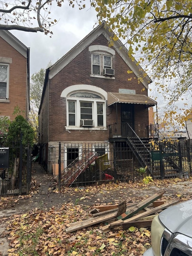 2342 S Trumbull Ave, Chicago, IL 60623 - view of front of home featuring fence, cooling unit, stairway, and brick siding