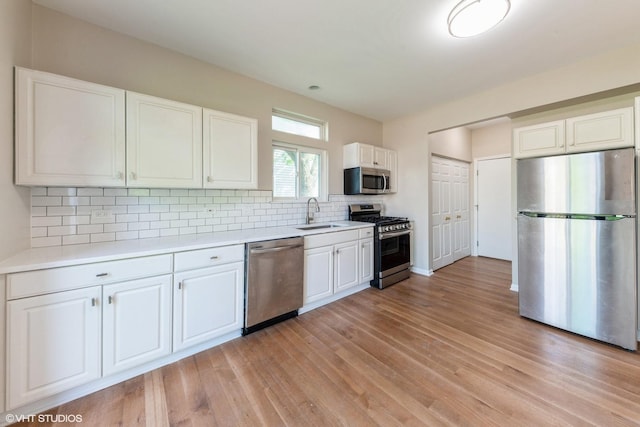 403 W Boxwood Ct, Round Lake, IL 60073 - kitchen featuring stainless steel appliances, light wood finished floors, light countertops, and white cabinets
