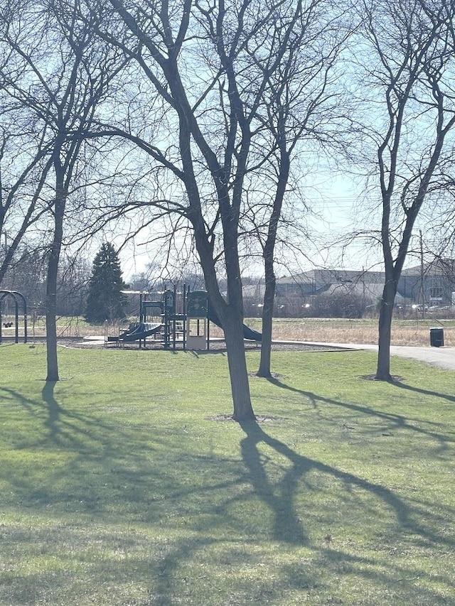 surrounding community featuring a lawn and playground community