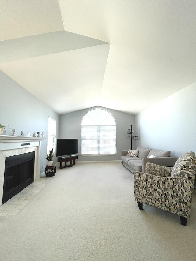 carpeted living room featuring lofted ceiling and a fireplace