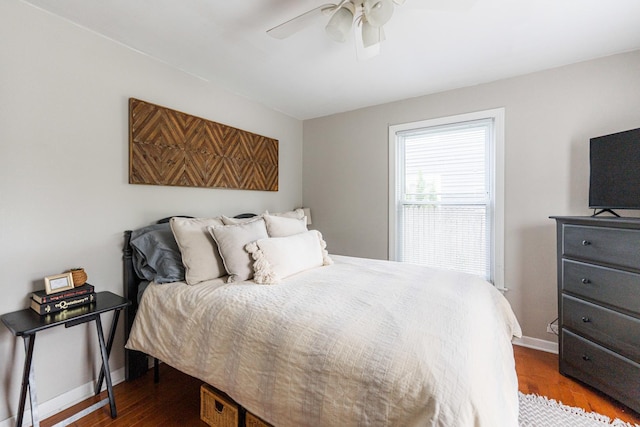 bedroom with baseboards, dark wood-style flooring, and ceiling fan