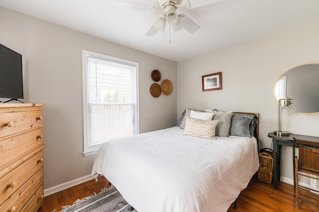 bedroom featuring baseboards, a ceiling fan, and dark wood finished floors