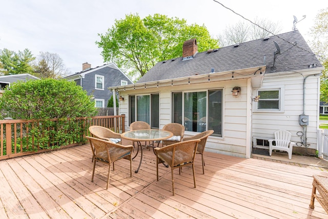 wooden deck featuring outdoor dining area
