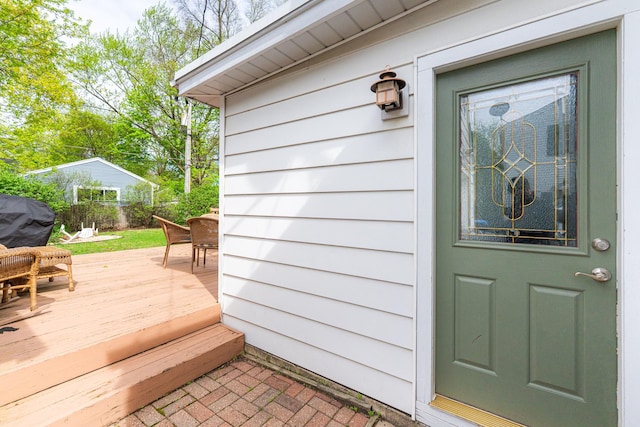 doorway to property with fence and a deck