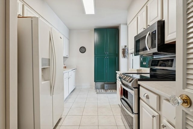 1240 N Lake Shore Dr Unit 9B, Chicago, IL 60610 - kitchen with light countertops, white cabinetry, light tile patterned flooring, and stainless steel appliances
