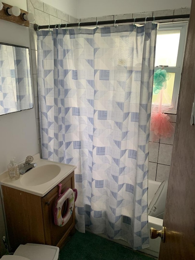 bathroom with shower / bathtub combination with curtain and vanity