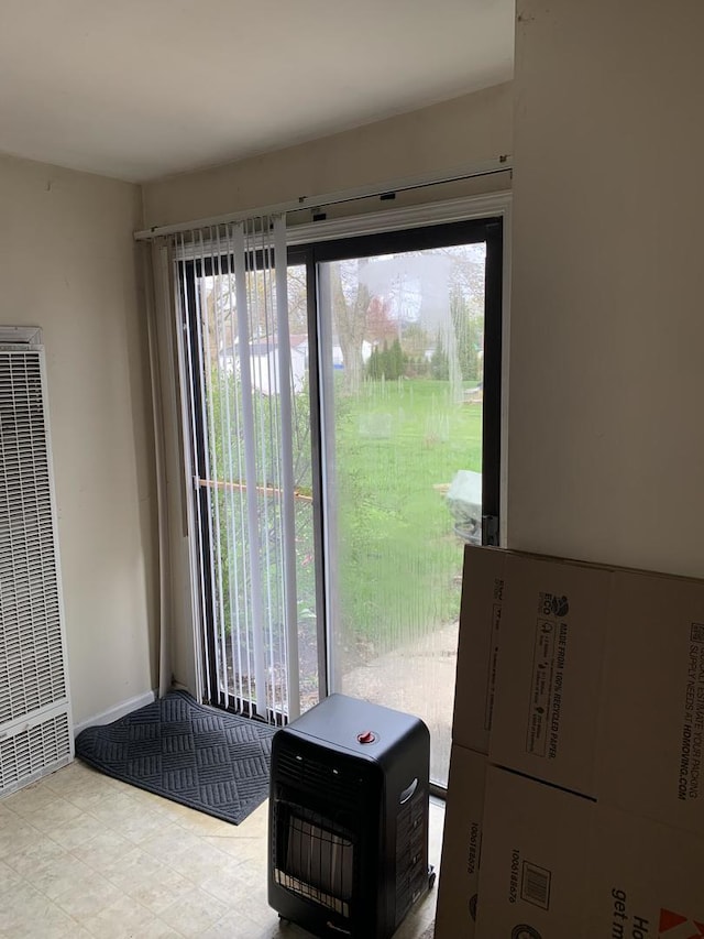 doorway featuring a heating unit, heating unit, and plenty of natural light