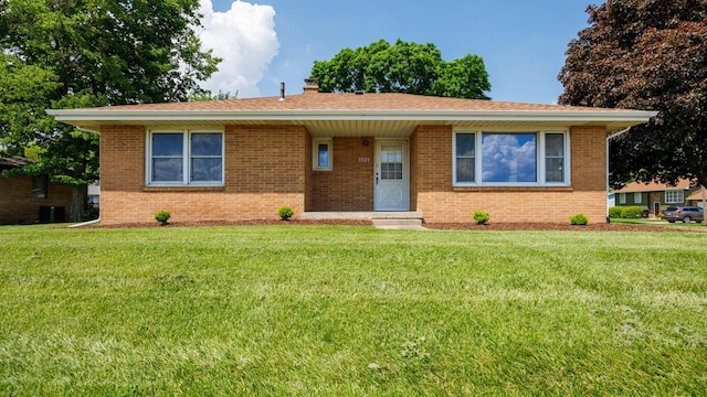 1201 S Mercer Ave, Bloomington, IL 61701 - view of front facade featuring a front lawn, brick siding, and a chimney