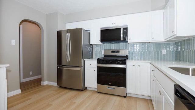 1201 S Mercer Ave, Bloomington, IL 61701 - kitchen featuring stainless steel appliances, light wood-type flooring, and backsplash