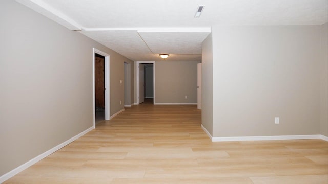 1201 S Mercer Ave, Bloomington, IL 61701 - hallway with light wood-style floors and baseboards