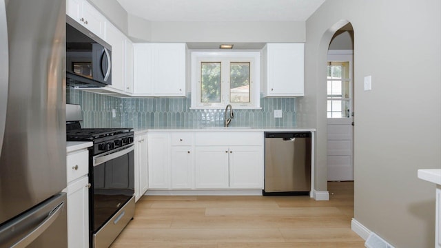 1201 S Mercer Ave, Bloomington, IL 61701 - kitchen with stainless steel appliances, a sink, light countertops, and plenty of natural light