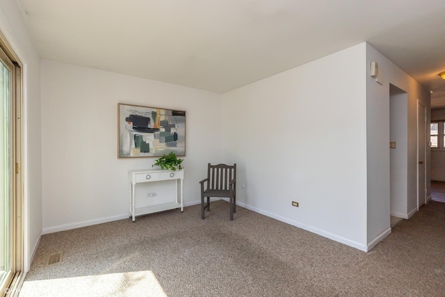 sitting room with baseboards, carpet flooring, and visible vents