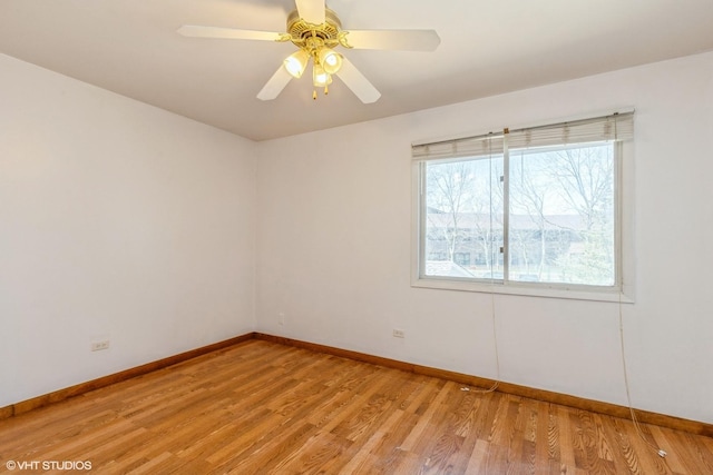 empty room featuring baseboards, a ceiling fan, and light wood-style flooring