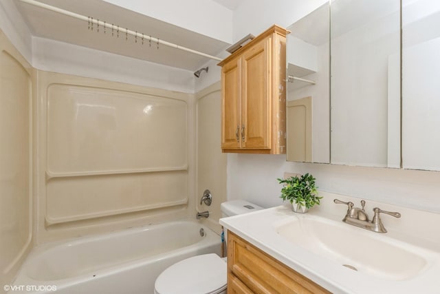 bathroom featuring vanity, bathtub / shower combination, and toilet