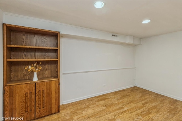 finished below grade area featuring baseboards, recessed lighting, light wood-style flooring, and visible vents