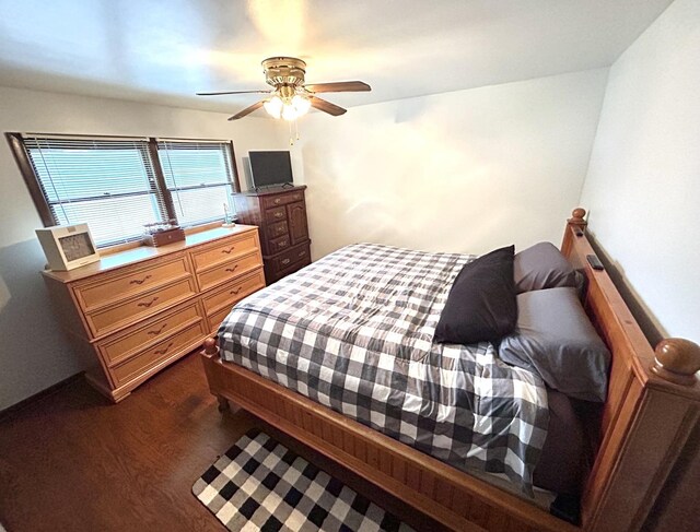 bedroom featuring a ceiling fan and dark wood-style flooring