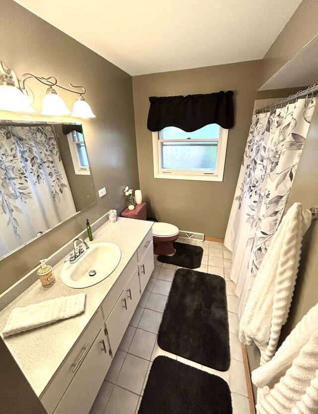 bathroom with vanity, tile patterned flooring, and toilet