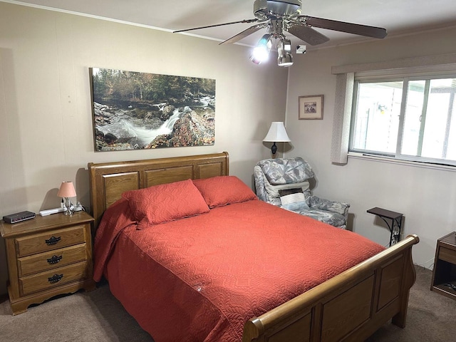 bedroom with ornamental molding, carpet, and a ceiling fan