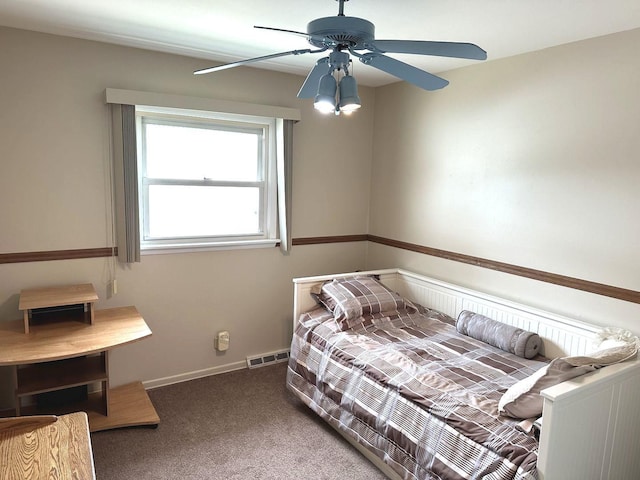 carpeted bedroom with ceiling fan and visible vents