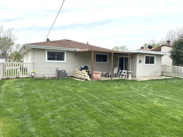 back of house with a yard, a patio, central AC, and fence
