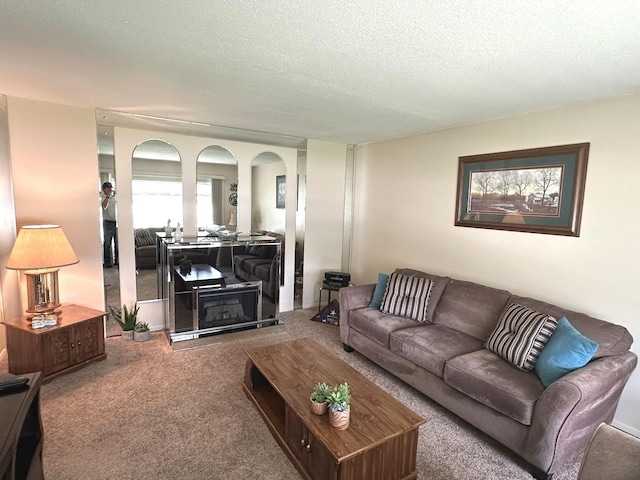 carpeted living room featuring a textured ceiling
