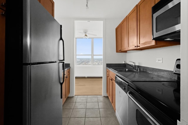 655 W Irving Park Rd Unit 4417, Chicago, IL 60613 - kitchen featuring brown cabinets, light tile patterned flooring, a sink, stainless steel appliances, and a ceiling fan