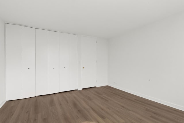 655 W Irving Park Rd Unit 4417, Chicago, IL 60613 - unfurnished bedroom featuring baseboards, wood finished floors, and a closet