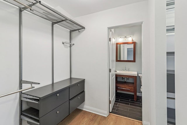 walk in closet featuring wood finished floors