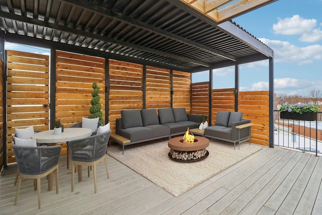 deck with an outdoor living space with a fire pit and outdoor dining space