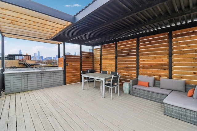 wooden terrace with a city view and outdoor dining area