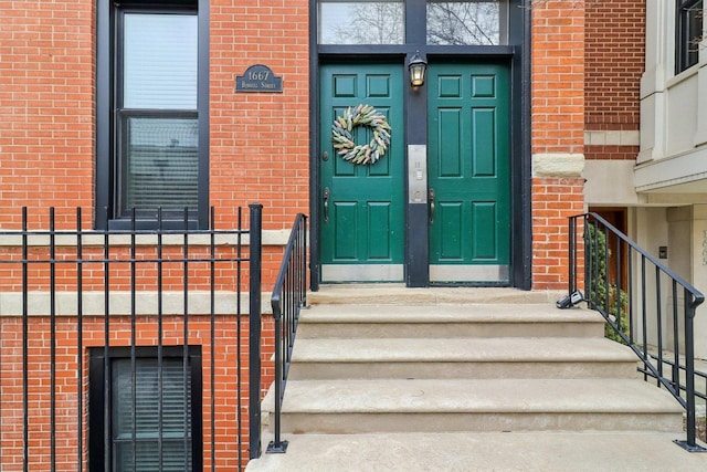 doorway to property with brick siding