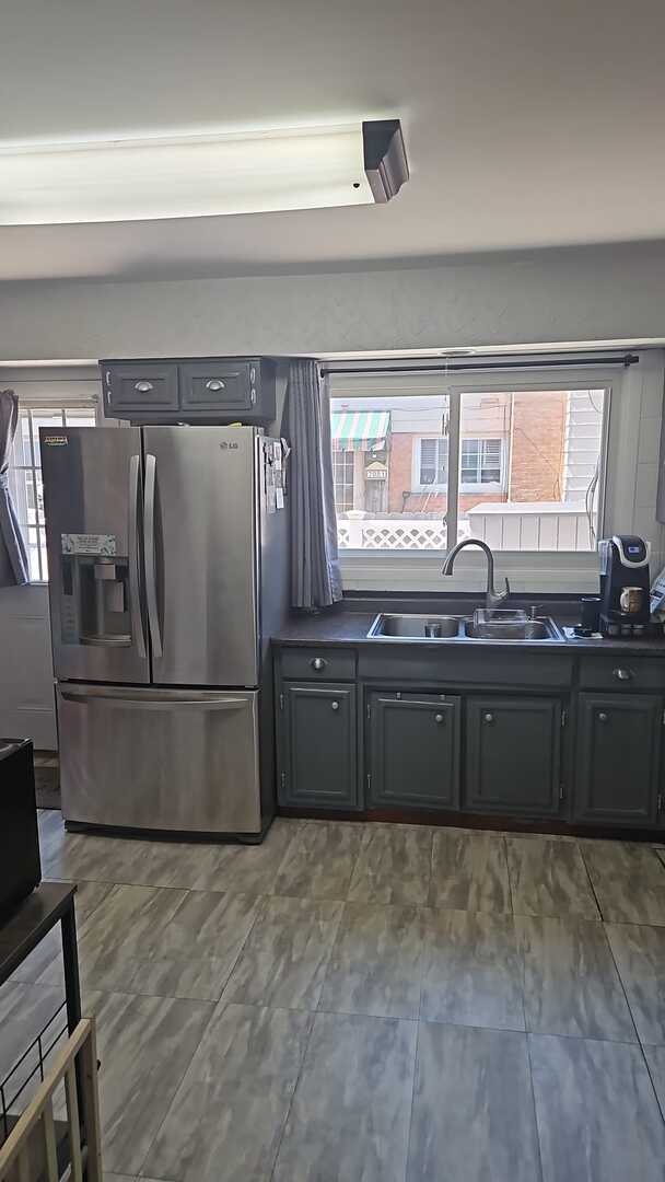 7013 W Greenleaf Ave, Niles, IL 60714 - kitchen with a sink, stainless steel fridge with ice dispenser, and dark countertops