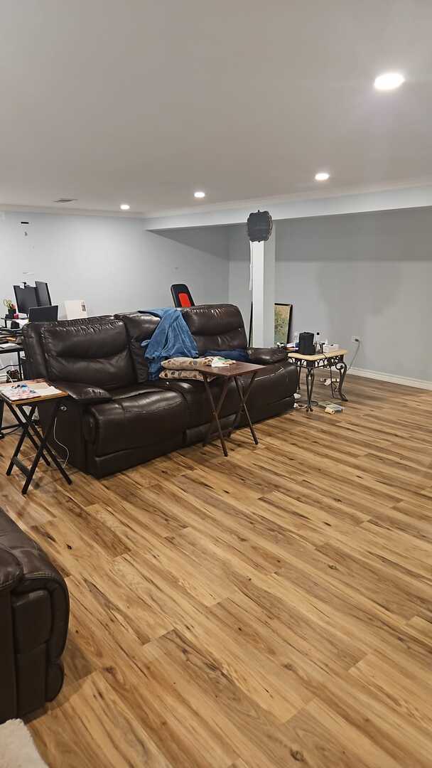 7013 W Greenleaf Ave, Niles, IL 60714 - living area with light wood-type flooring and recessed lighting