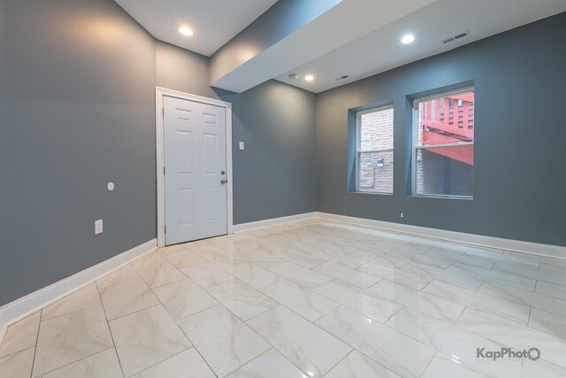 empty room featuring recessed lighting, baseboards, visible vents, and marble finish floor