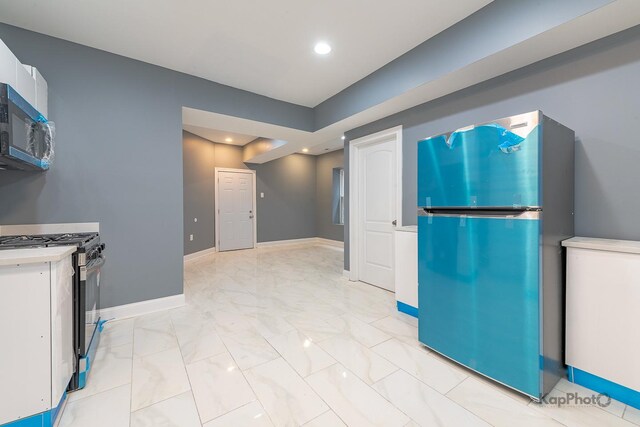 kitchen with white cabinets, marble finish floor, stainless steel appliances, baseboards, and recessed lighting