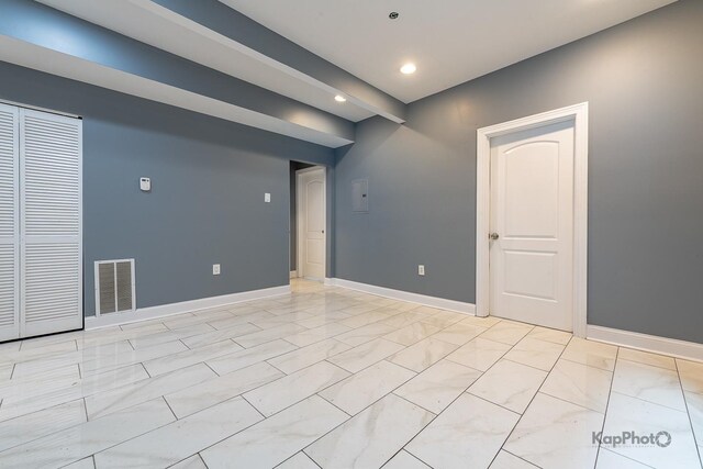 spare room with recessed lighting, baseboards, marble finish floor, and visible vents